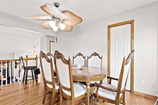 1005 Granada Dr, Raymore, MO 64083 - dining area with a chandelier, light wood-type flooring, and ceiling fan