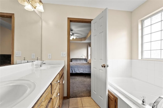 1005 Granada Dr, Raymore, MO 64083 - ensuite bathroom with double vanity, tile patterned flooring, a garden tub, and a ceiling fan