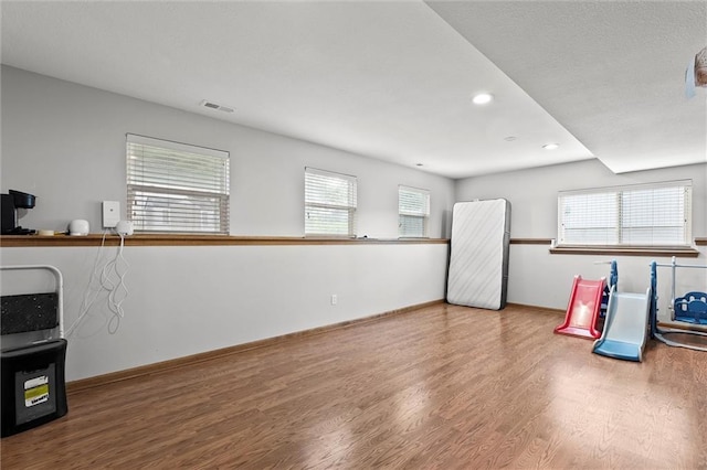 1005 Granada Dr, Raymore, MO 64083 - game room featuring wood finished floors and recessed lighting