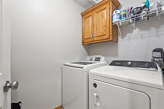 1005 Granada Dr, Raymore, MO 64083 - laundry area with cabinet space and washing machine and clothes dryer