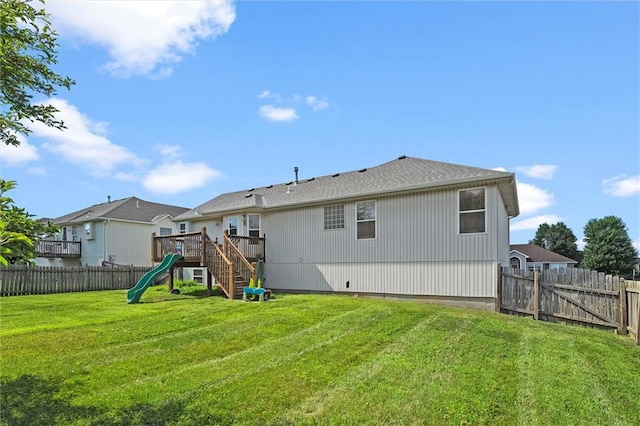 1005 Granada Dr, Raymore, MO 64083 - back of property with a fenced backyard and a playground