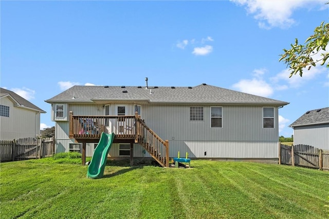 1005 Granada Dr, Raymore, MO 64083 - rear view of house featuring a fenced backyard, a playground, a gate, and a wooden deck
