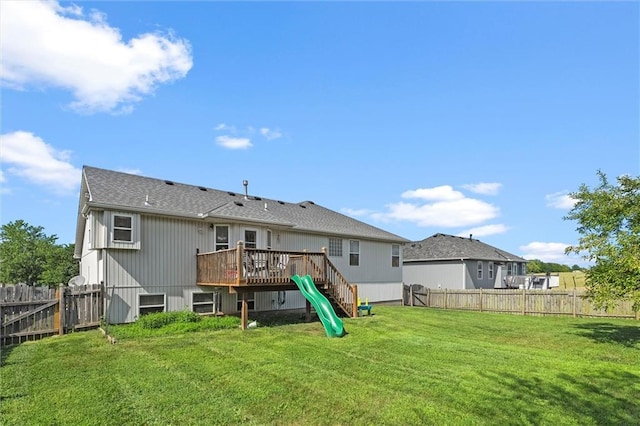 1005 Granada Dr, Raymore, MO 64083 - rear view of property with a deck, a fenced backyard, and roof with shingles