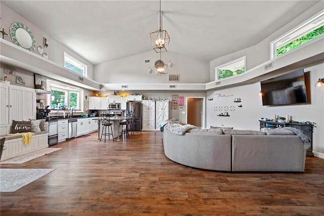 4815 Cheyenne Ln, Mclouth, KS 66054 - living area featuring high vaulted ceiling, a chandelier, and dark wood-type flooring