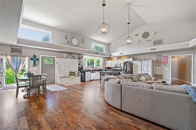 4815 Cheyenne Ln, Mclouth, KS 66054 - living area with high vaulted ceiling, wood finished floors, and wine cooler