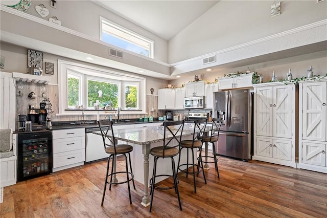 4815 Cheyenne Ln, Mclouth, KS 66054 - kitchen with stainless steel appliances, beverage cooler, tasteful backsplash, open shelves, and high vaulted ceiling
