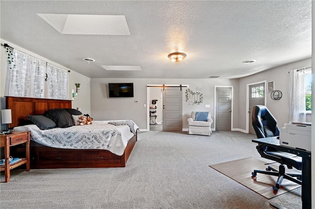 4815 Cheyenne Ln, Mclouth, KS 66054 - bedroom featuring a barn door, carpet floors, a textured ceiling, a skylight, and an office area