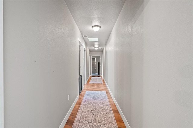 4815 Cheyenne Ln, Mclouth, KS 66054 - hallway with light wood-style flooring and a textured ceiling
