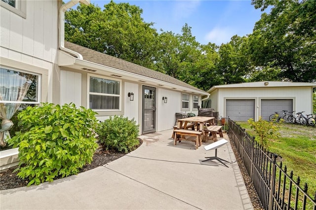 4815 Cheyenne Ln, Mclouth, KS 66054 - view of patio with outdoor dining space, an outdoor structure, and a garage