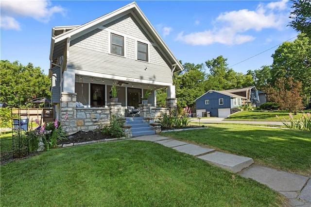 6000 Cherry St, Kansas City, MO 64110 - view of front of property with covered porch and a front yard