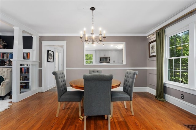 6000 Cherry St, Kansas City, MO 64110 - dining room with a chandelier, wood finished floors, and crown molding