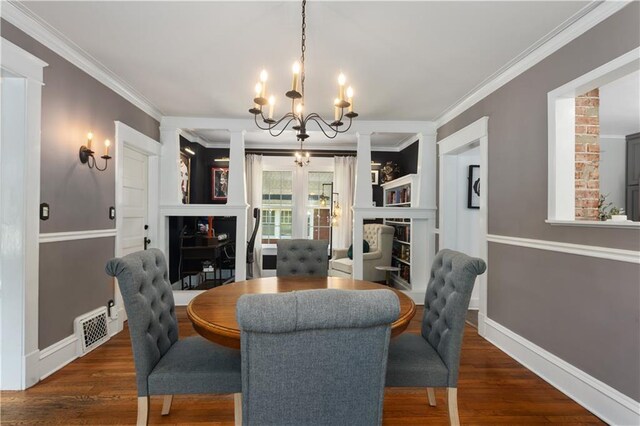6000 Cherry St, Kansas City, MO 64110 - dining area featuring a chandelier, crown molding, wood finished floors, and a fireplace