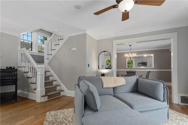 6000 Cherry St, Kansas City, MO 64110 - living room with stairs, wood finished floors, ceiling fan, ornamental molding, and a chandelier