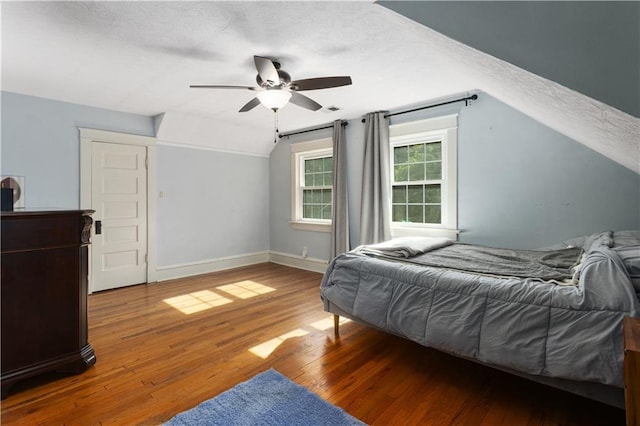 6000 Cherry St, Kansas City, MO 64110 - bedroom with a textured ceiling, vaulted ceiling, wood finished floors, and ceiling fan
