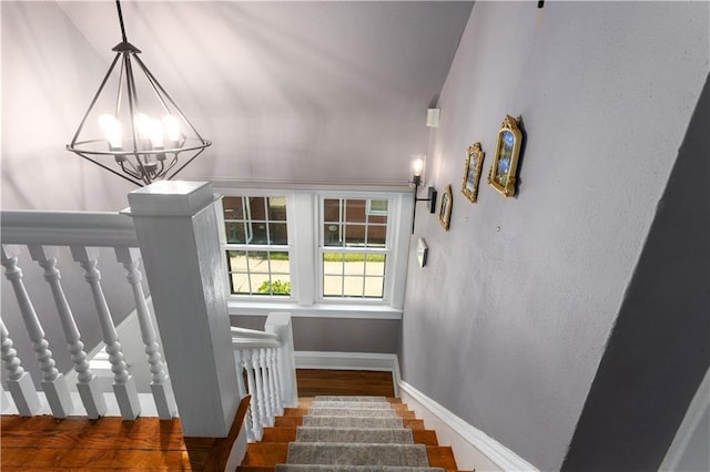 6000 Cherry St, Kansas City, MO 64110 - stairway featuring a chandelier and wood finished floors