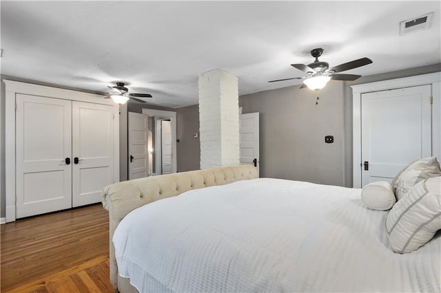 6000 Cherry St, Kansas City, MO 64110 - bedroom featuring decorative columns, wood finished floors, and ceiling fan