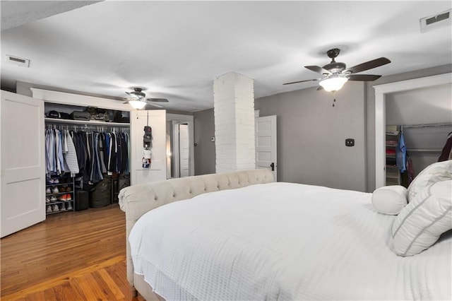 6000 Cherry St, Kansas City, MO 64110 - bedroom with a closet, wood finished floors, ceiling fan, and decorative columns