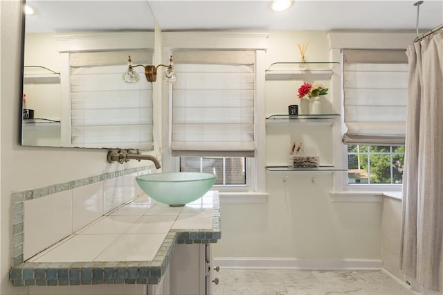 6000 Cherry St, Kansas City, MO 64110 - bathroom with marble look tile flooring, vanity, and recessed lighting