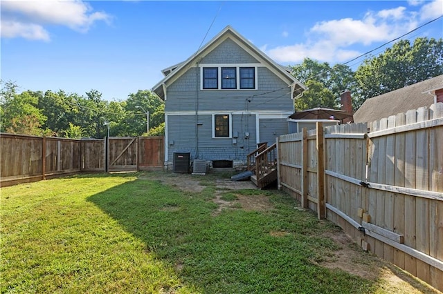 6000 Cherry St, Kansas City, MO 64110 - rear view of property featuring a fenced backyard and a gate
