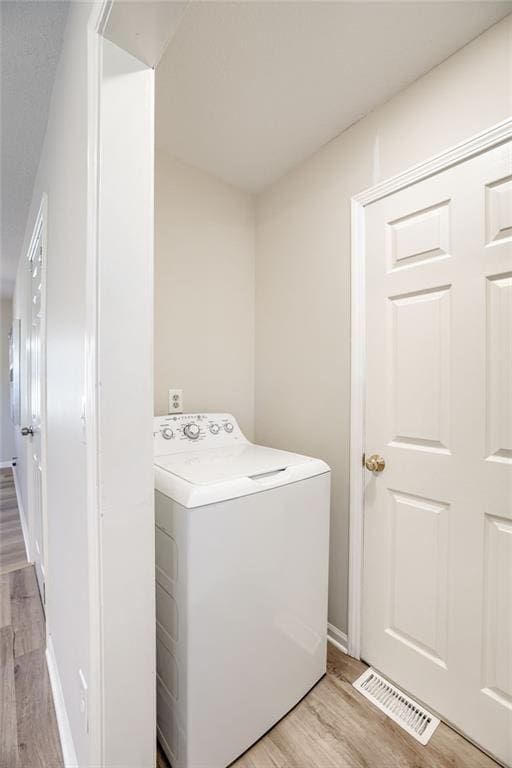 10201 Hillcrest Rd, Kansas City, MO 64134 - laundry area with washer / dryer and light wood-style flooring