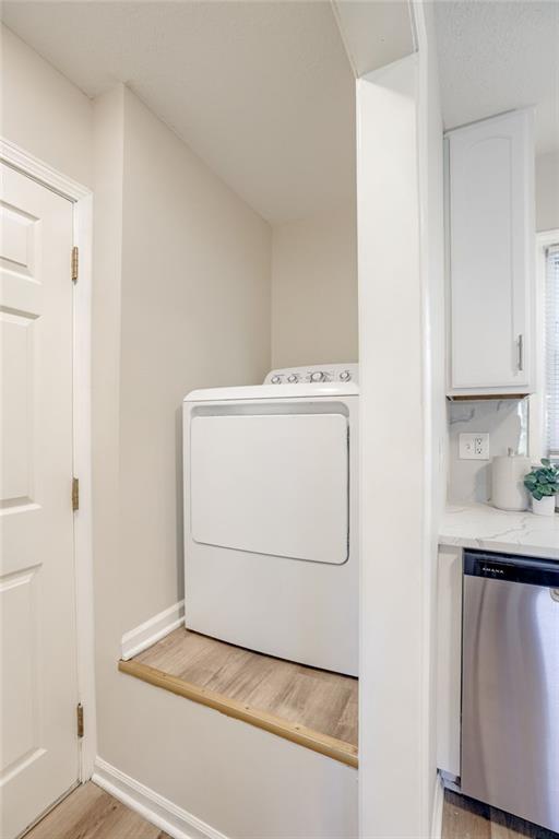 10201 Hillcrest Rd, Kansas City, MO 64134 - laundry area featuring washer / clothes dryer and light wood-type flooring