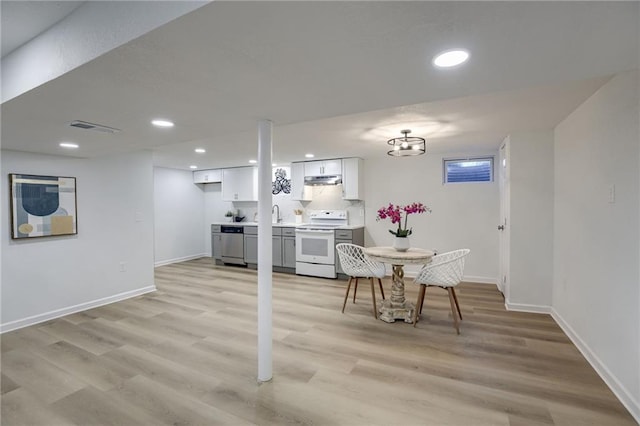 10201 Hillcrest Rd, Kansas City, MO 64134 - dining room featuring light wood-style floors and recessed lighting