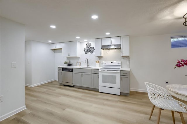 10201 Hillcrest Rd, Kansas City, MO 64134 - kitchen with electric range, under cabinet range hood, dishwasher, gray cabinetry, and light wood-style flooring