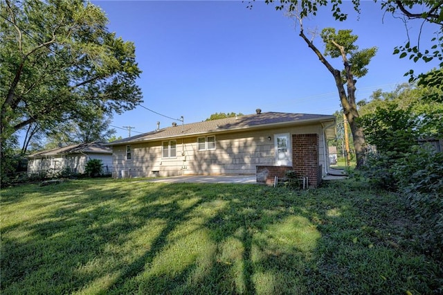 10201 Hillcrest Rd, Kansas City, MO 64134 - rear view of property with a lawn and a patio