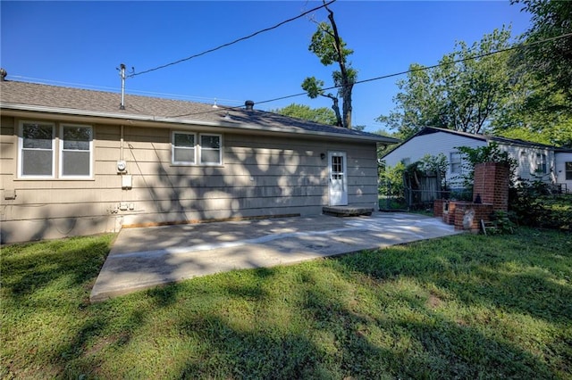 10201 Hillcrest Rd, Kansas City, MO 64134 - rear view of property featuring a patio, a lawn, and a shingled roof
