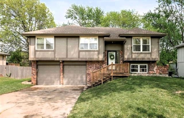 820 S Virginia Ln, Olathe, KS 66061 - bi-level home featuring an attached garage, concrete driveway, and brick siding