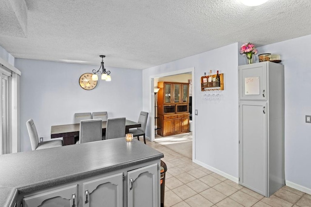 820 S Virginia Ln, Olathe, KS 66061 - dining space featuring a textured ceiling, a chandelier, and light tile patterned floors