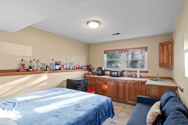 820 S Virginia Ln, Olathe, KS 66061 - bedroom with a textured ceiling and light tile patterned floors