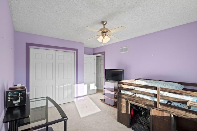 820 S Virginia Ln, Olathe, KS 66061 - carpeted bedroom with a closet, a ceiling fan, and a textured ceiling