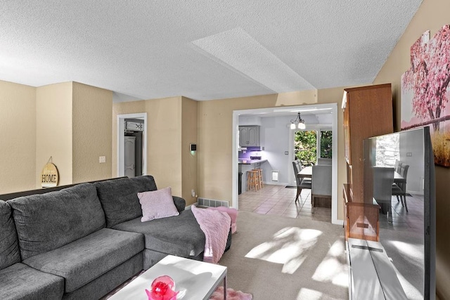 820 S Virginia Ln, Olathe, KS 66061 - living room featuring a textured ceiling and a chandelier