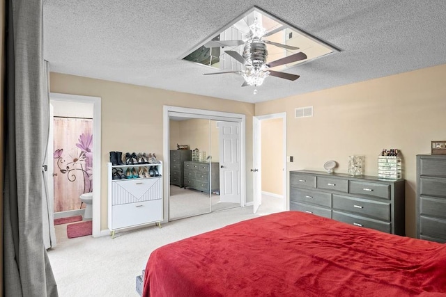 820 S Virginia Ln, Olathe, KS 66061 - carpeted bedroom with a textured ceiling, ensuite bath, and a ceiling fan