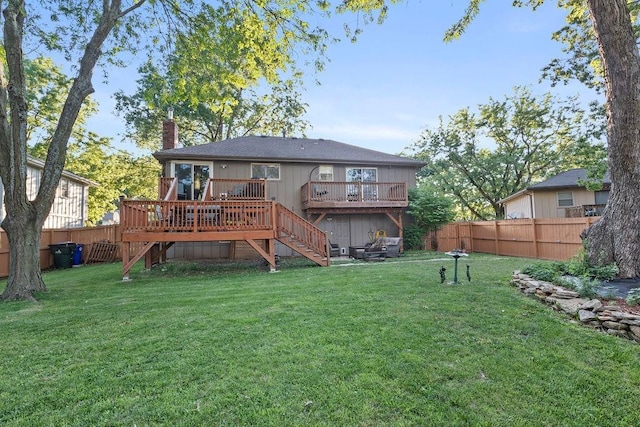 820 S Virginia Ln, Olathe, KS 66061 - rear view of house with a fenced backyard, a chimney, a deck, and stairway