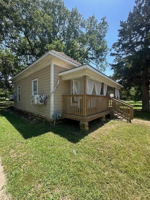 522 S 11th St, Independence, KS 67301 - view of side of home featuring a yard and a wooden deck