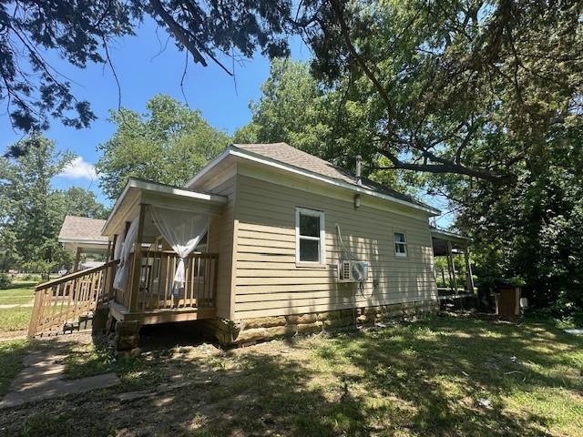 522 S 11th St, Independence, KS 67301 - view of home's exterior with a wooden deck and a lawn