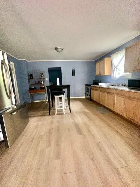522 S 11th St, Independence, KS 67301 - kitchen featuring a textured ceiling, light brown cabinetry, light wood finished floors, and light countertops