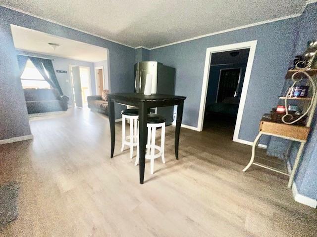 522 S 11th St, Independence, KS 67301 - dining space featuring wood finished floors and a textured ceiling