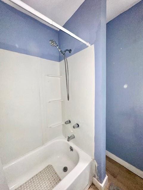 522 S 11th St, Independence, KS 67301 - bathroom featuring tub / shower combination and baseboards