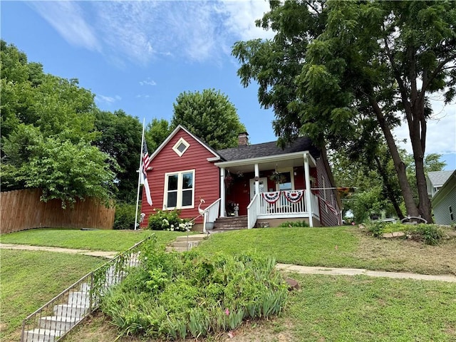 715 Harmon St, Saint Joseph, MO 64504 - bungalow featuring covered porch, a chimney, and stairway