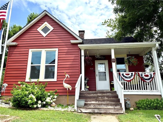715 Harmon St, Saint Joseph, MO 64504 - view of front facade with a chimney and a porch
