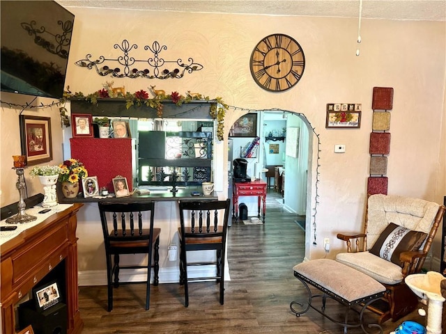 715 Harmon St, Saint Joseph, MO 64504 - dining space with dark wood-style flooring, arched walkways, and a textured ceiling