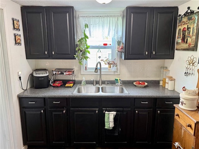 715 Harmon St, Saint Joseph, MO 64504 - kitchen featuring tasteful backsplash and dark cabinets