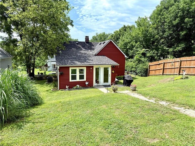 715 Harmon St, Saint Joseph, MO 64504 - back of house with roof with shingles and a chimney