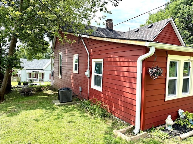 715 Harmon St, Saint Joseph, MO 64504 - view of side of home featuring a chimney, a lawn, and a shingled roof