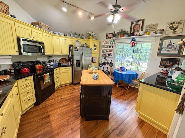 24604 E 327th St, Harrisonville, MO 64701 - kitchen with stainless steel appliances, track lighting, vaulted ceiling, butcher block counters, and a ceiling fan