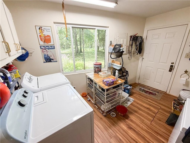 24604 E 327th St, Harrisonville, MO 64701 - laundry room featuring washing machine and clothes dryer, light wood-type flooring, and cabinet space