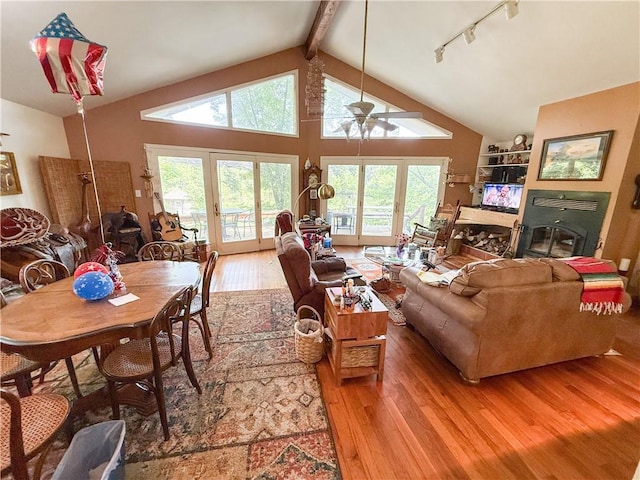 24604 E 327th St, Harrisonville, MO 64701 - living area featuring light wood-type flooring, a ceiling fan, a glass covered fireplace, and rail lighting